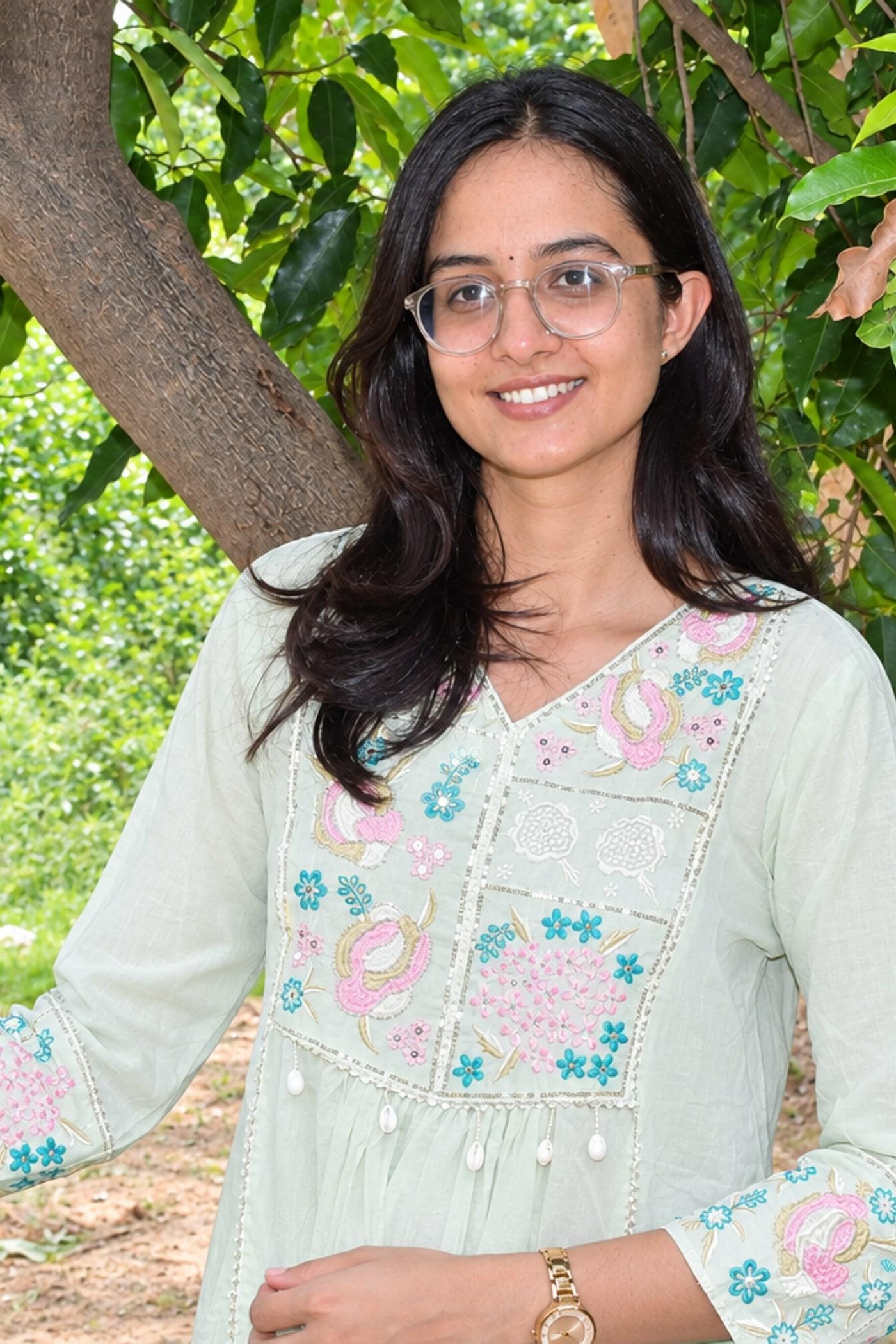 Mint pastel paisley kurta worn close, embroidered yoke with pearl tassels in view