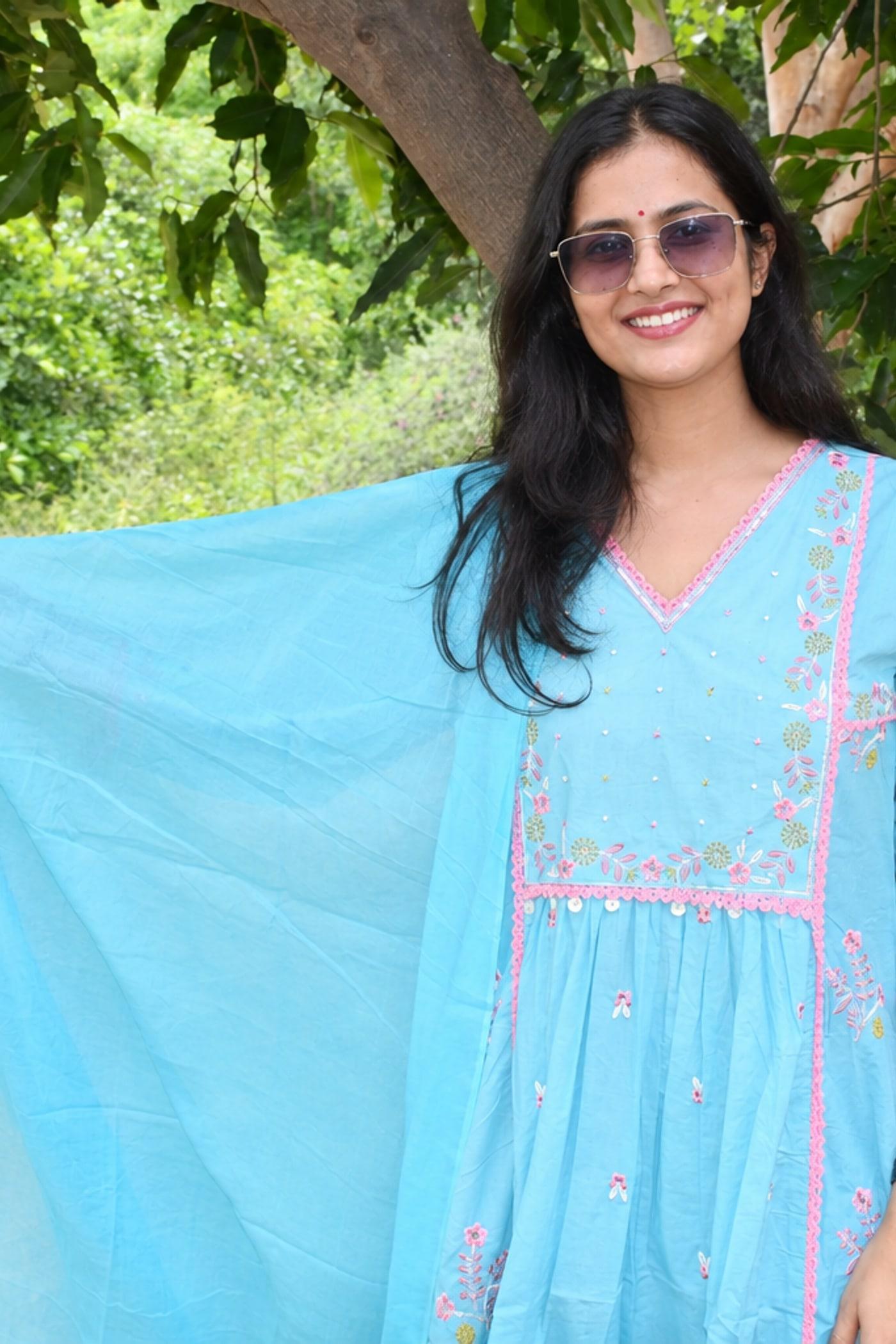 Sky Blue gathered kurta yoke seen close, pink floral embroidery and dupatta over the shoulder