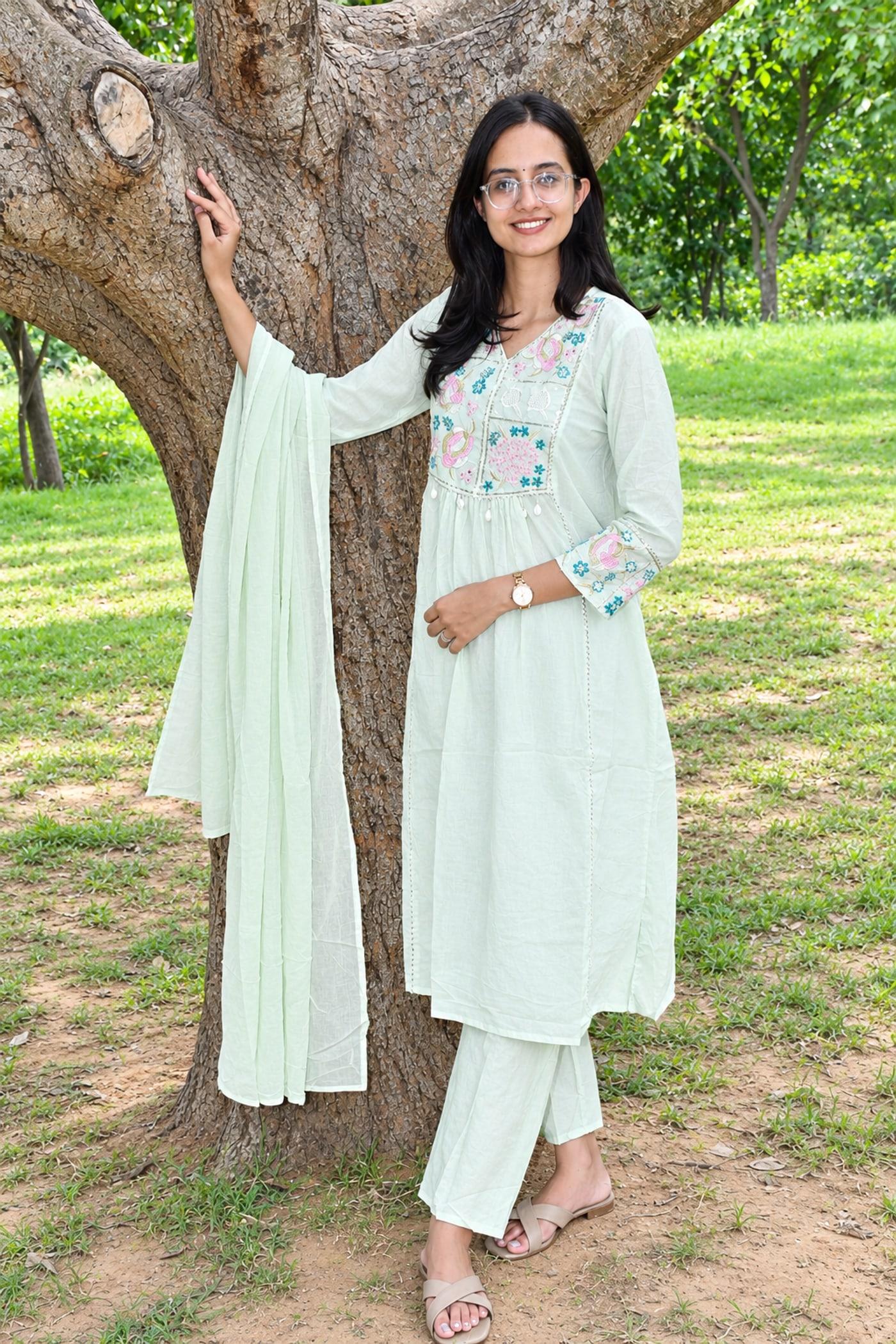 Mint pastel paisley suit set worn full length beside a tree, dupatta hanging