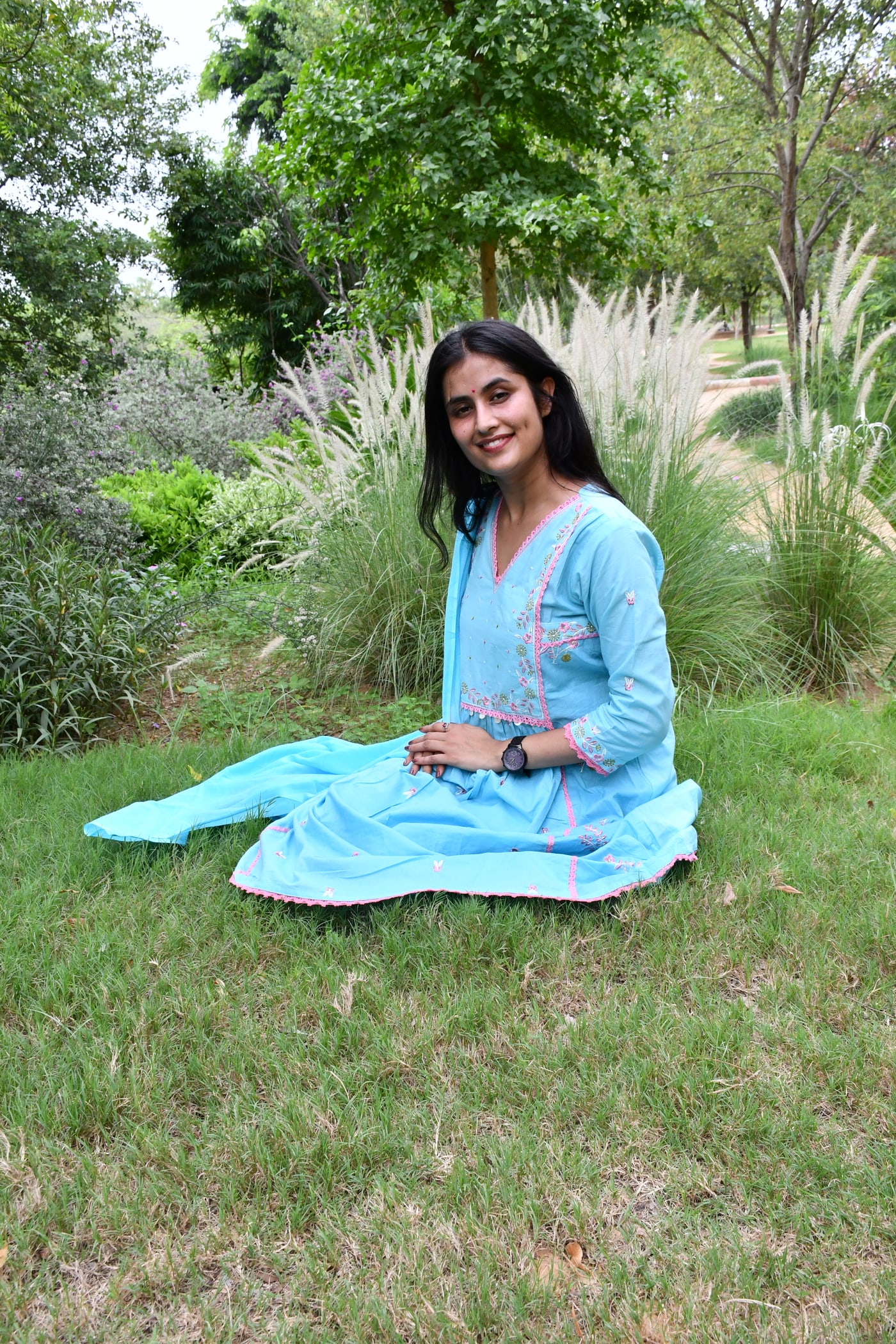Sky Blue gathered floral suit set worn seated on grass