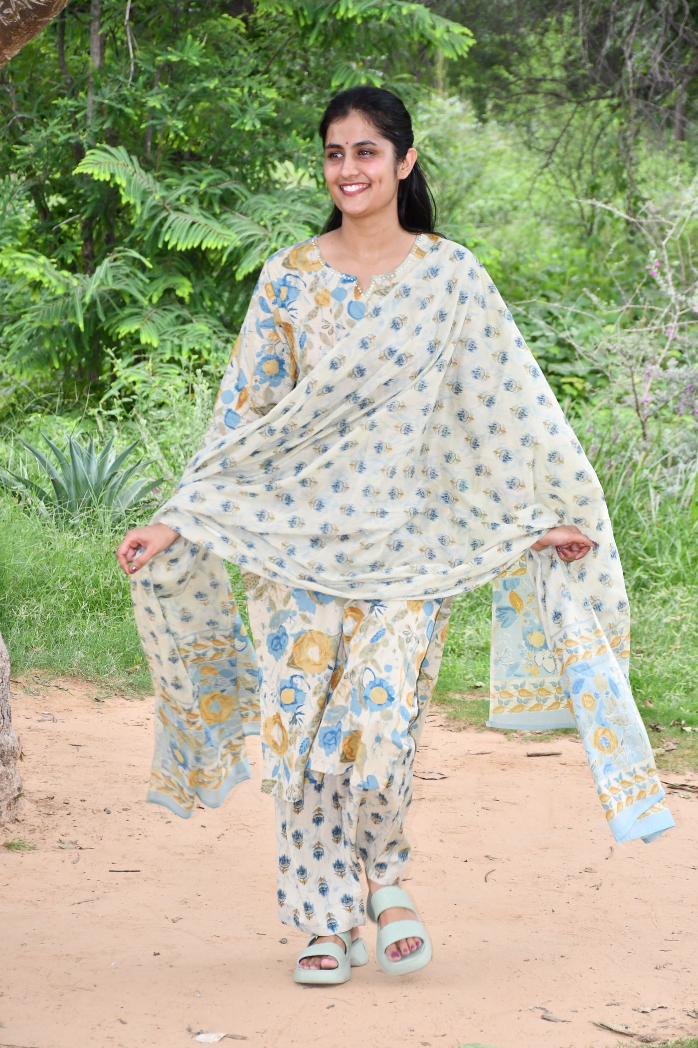 Ivory block print suit set with the dupatta held to both sides