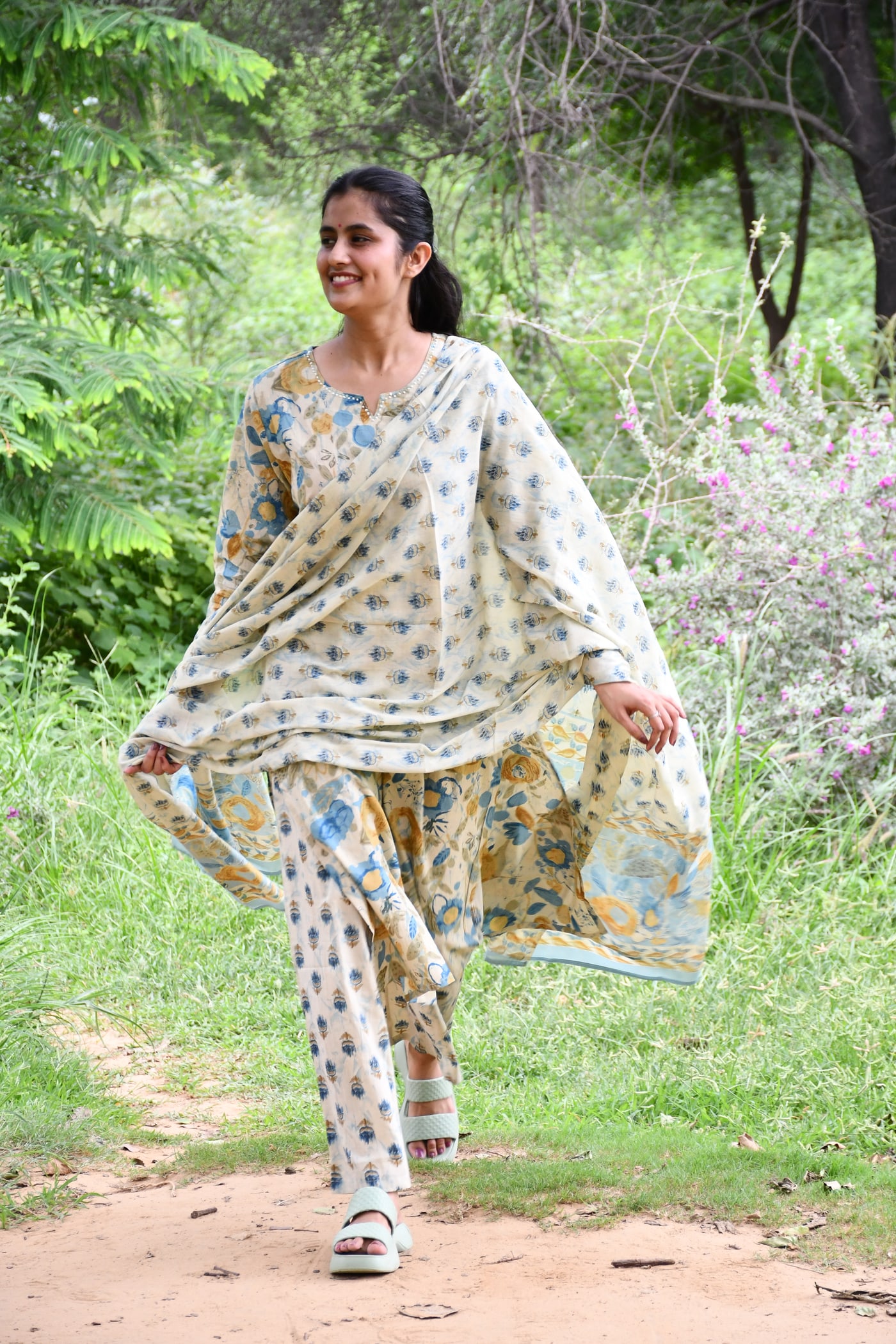 Ivory block print kurta worn mid-step, dupatta trailing