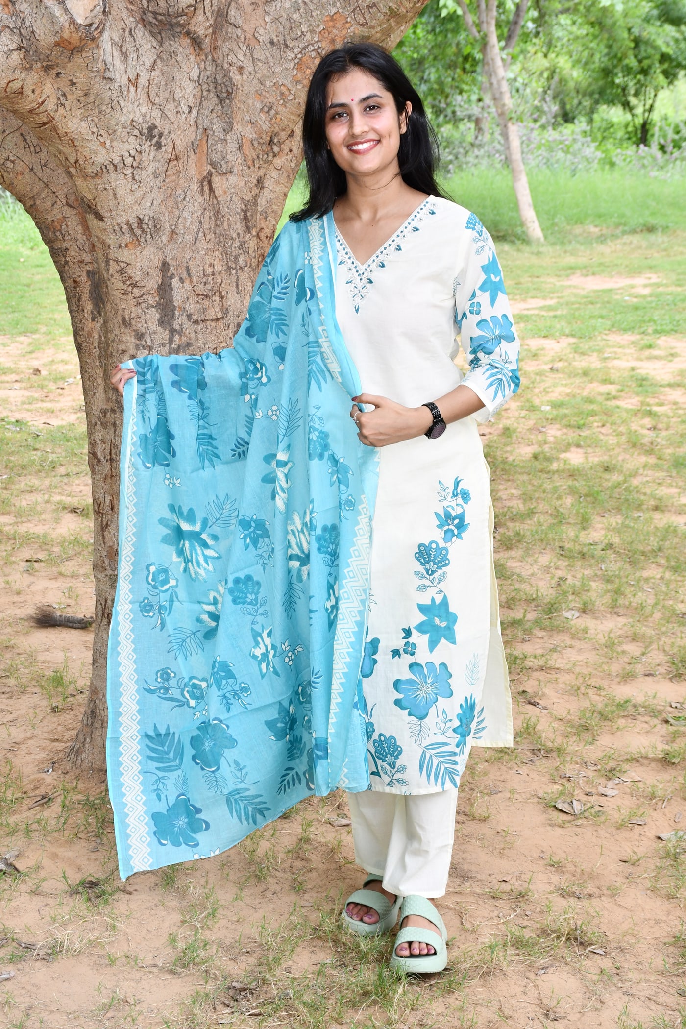Ivory suit set with teal floral print, dupatta hanging full length