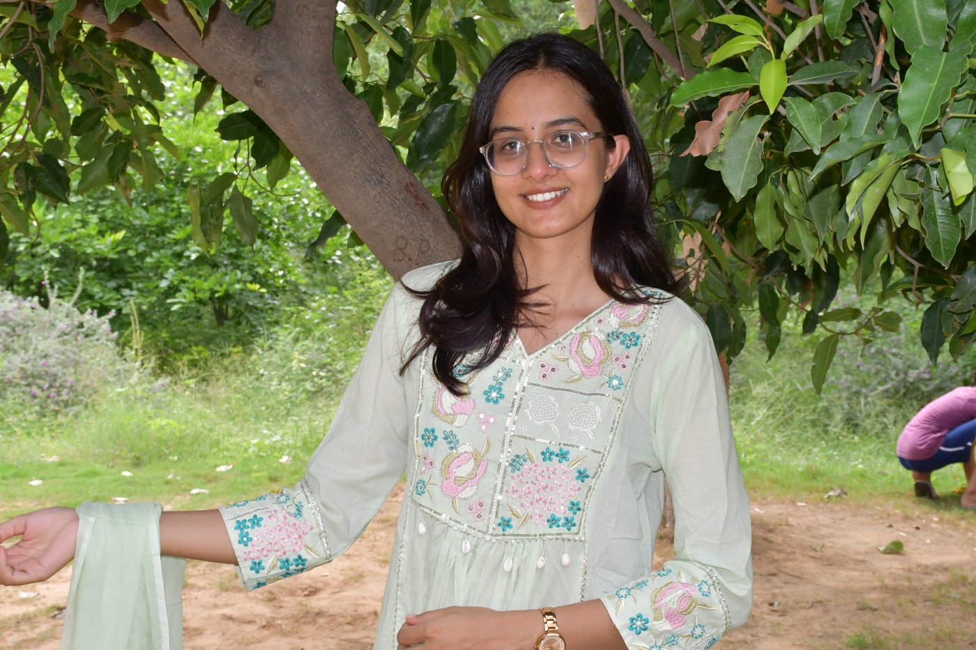 Mint pastel paisley kurta worn seated, cuff embroidery in view
