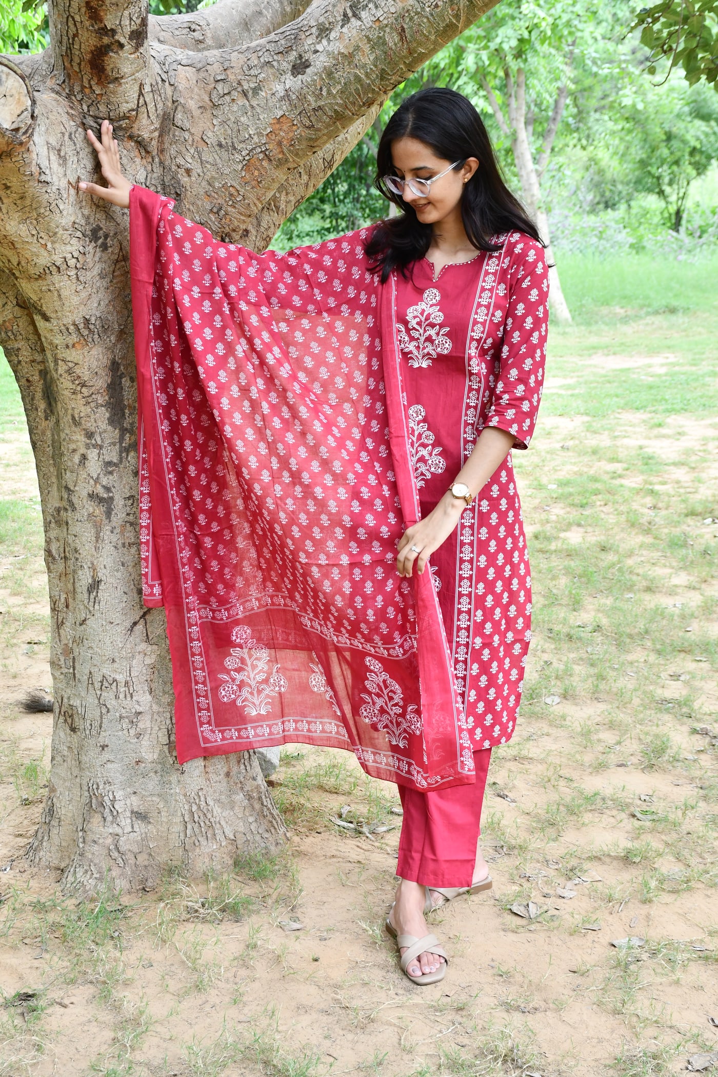 Rani Pink block print suit set worn full length beside a tree
