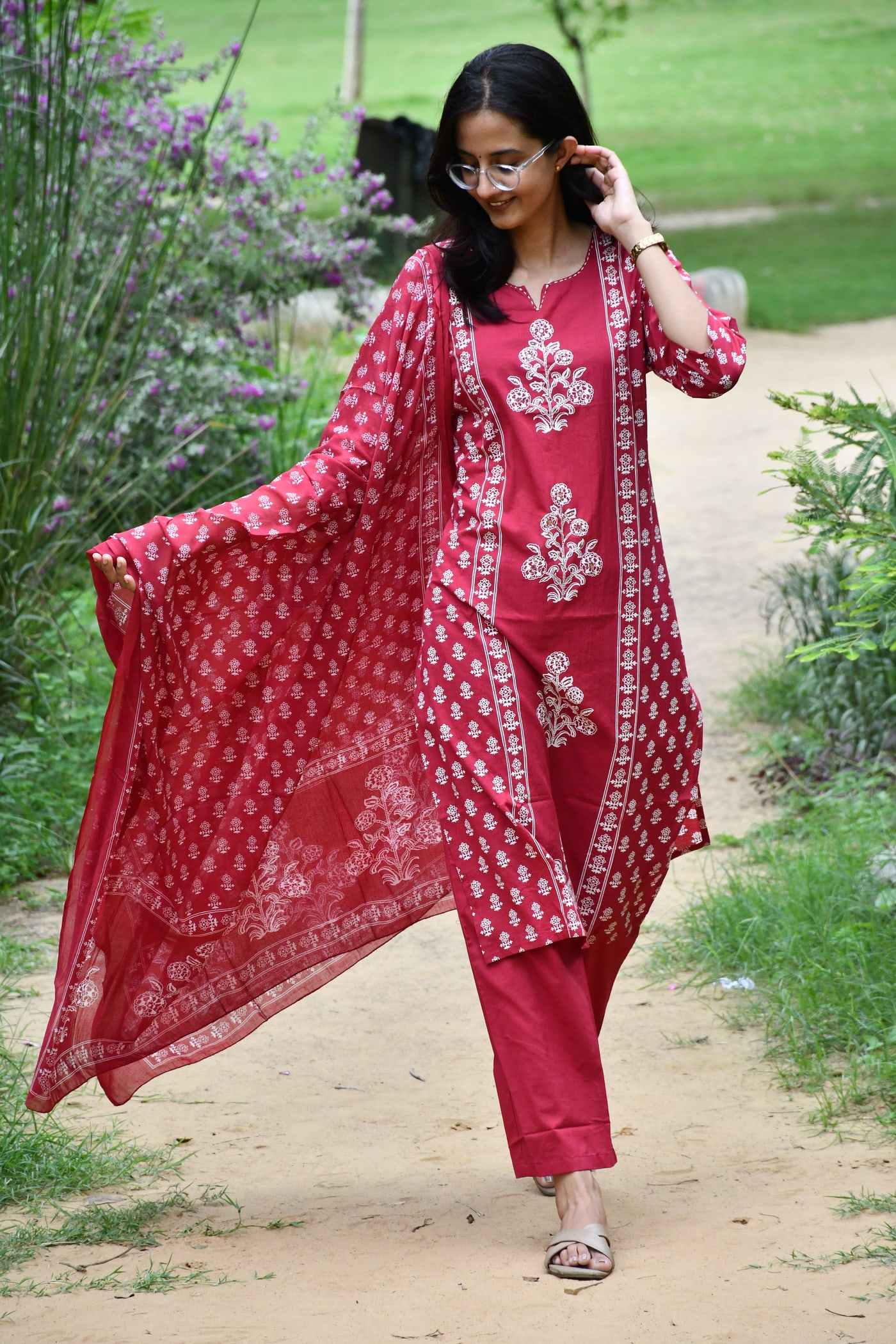 Rani Pink block print suit set worn on a garden path