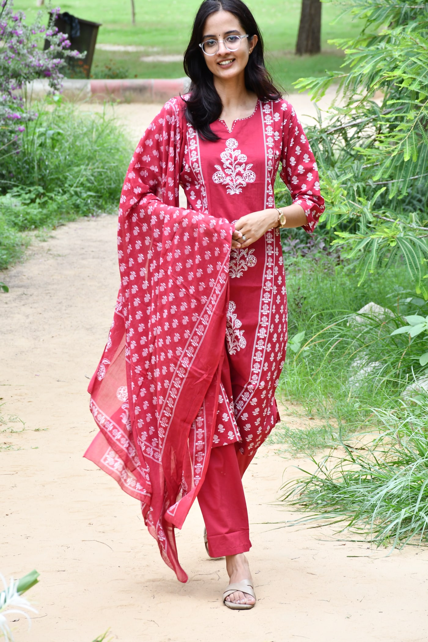 Rani Pink block print suit set worn walking, dupatta trailing