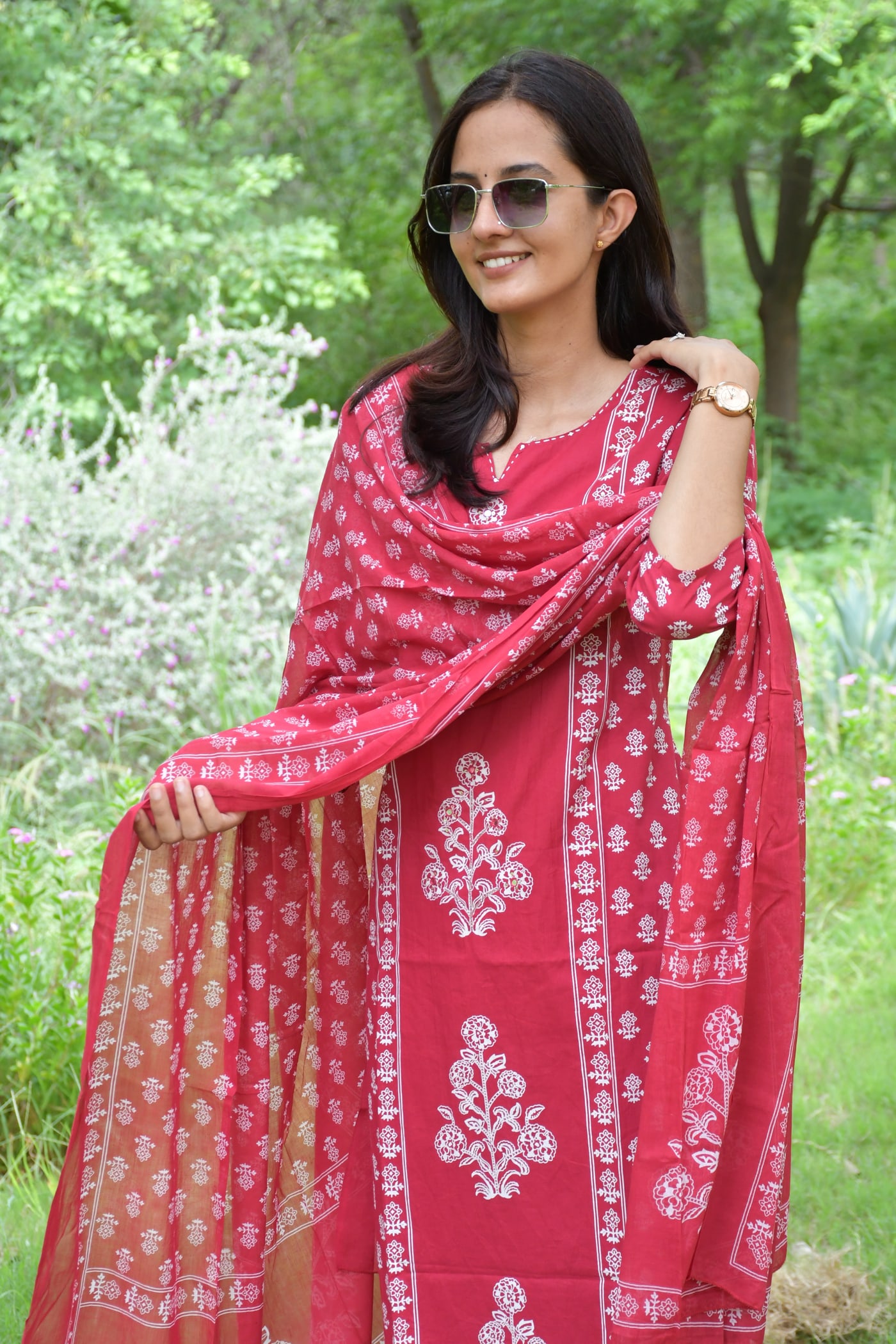 Rani Pink block print dupatta held up, bordered end in view