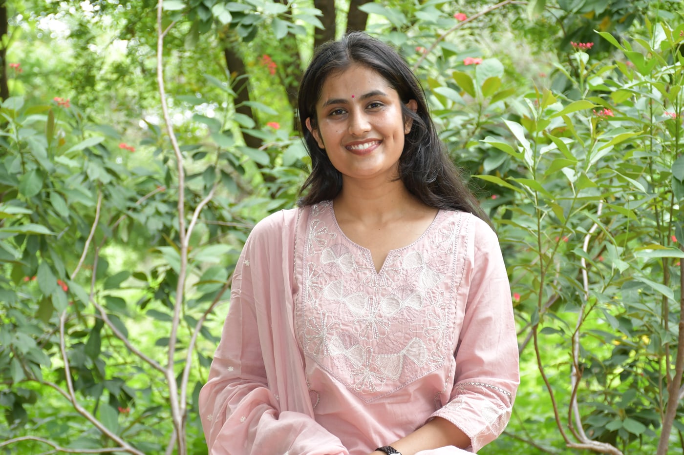 Dusty Rose kurta worn seated, cutwork neckline in view